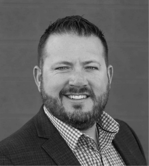 A man with a beard and jacket on.