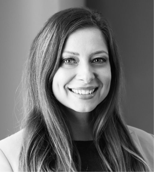 A woman with long hair smiling for the camera.