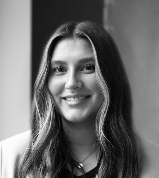 A woman with long hair smiling for the camera.