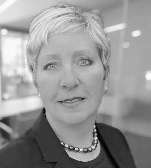 A black and white photo of a woman with short hair.