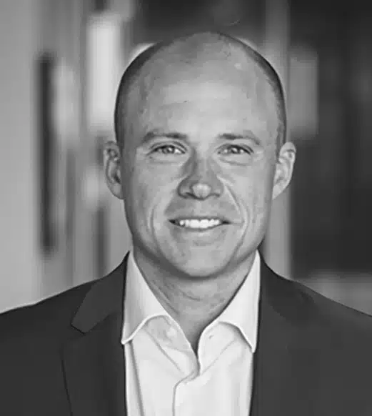 A black and white photo of a man in suit