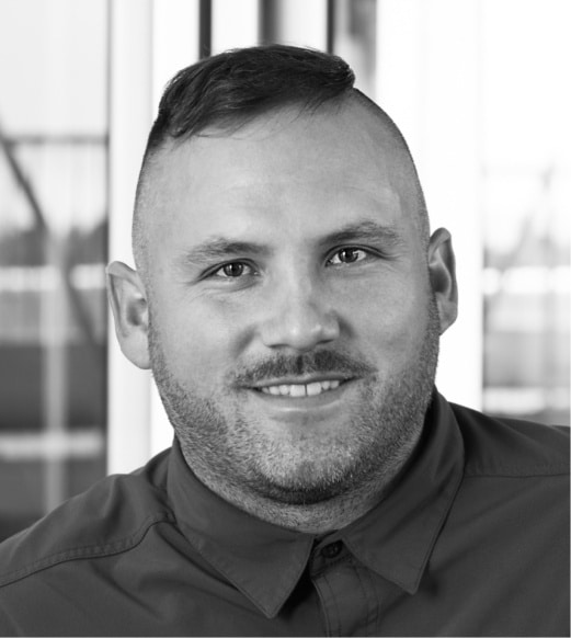 A man with a shaved head and beard.