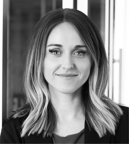 A woman with long hair is smiling for the camera.