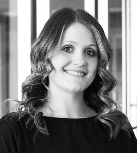 A woman with long hair is smiling for the camera.