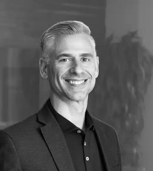 Smiling man in blazer and polo shirt