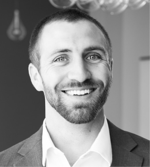 A man with a beard and suit jacket