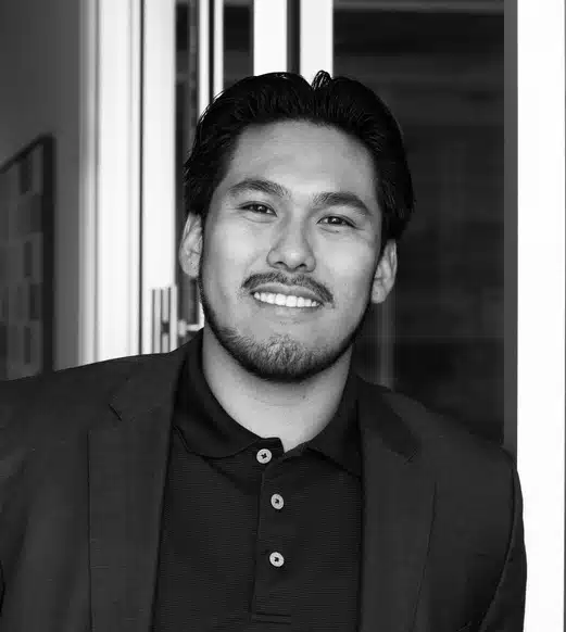 Smiling man in blazer and polo shirt
