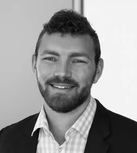 Smiling bearded man headshot in suit